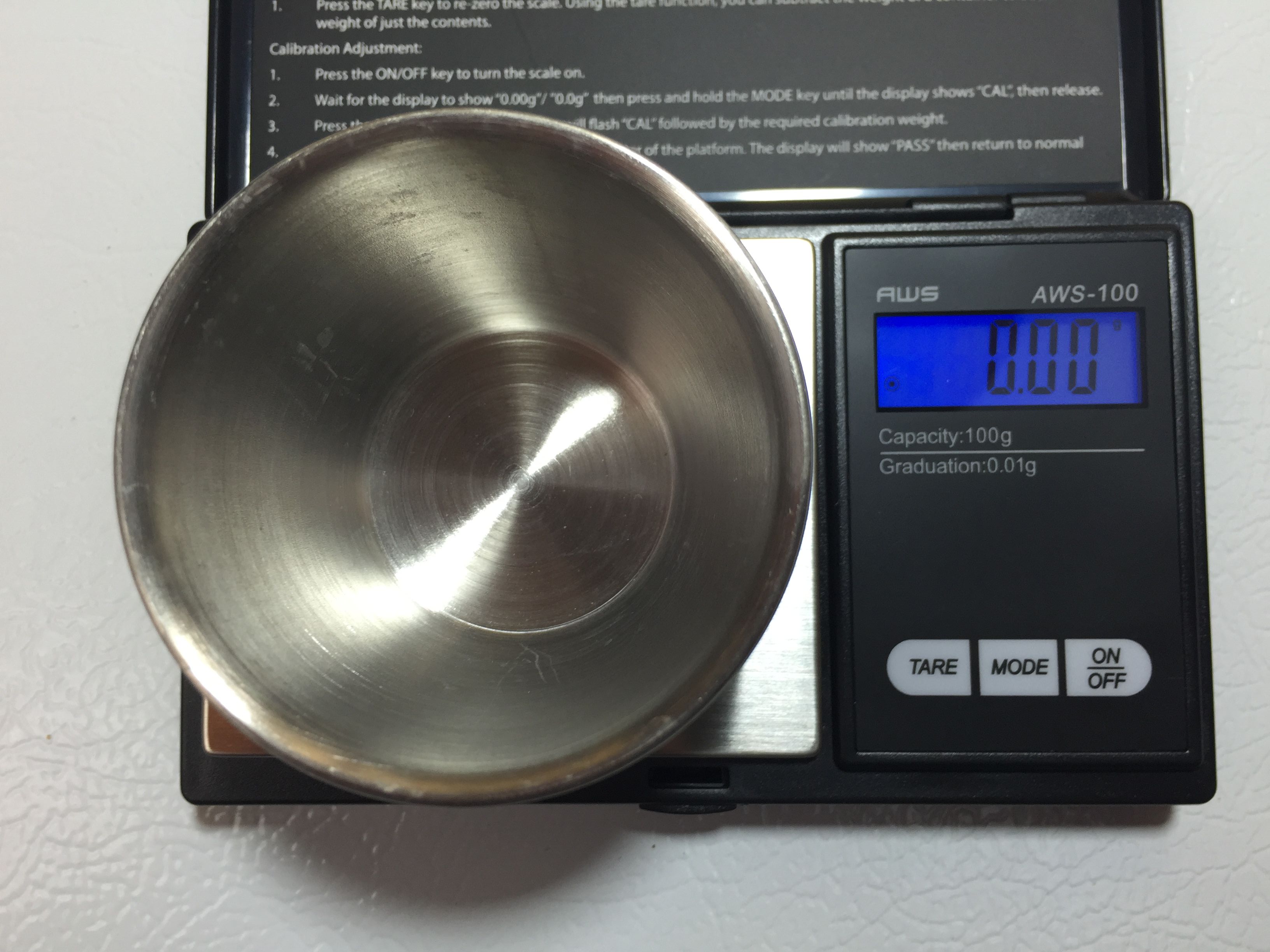 A picture of a scale with a bowl on it that's been tared